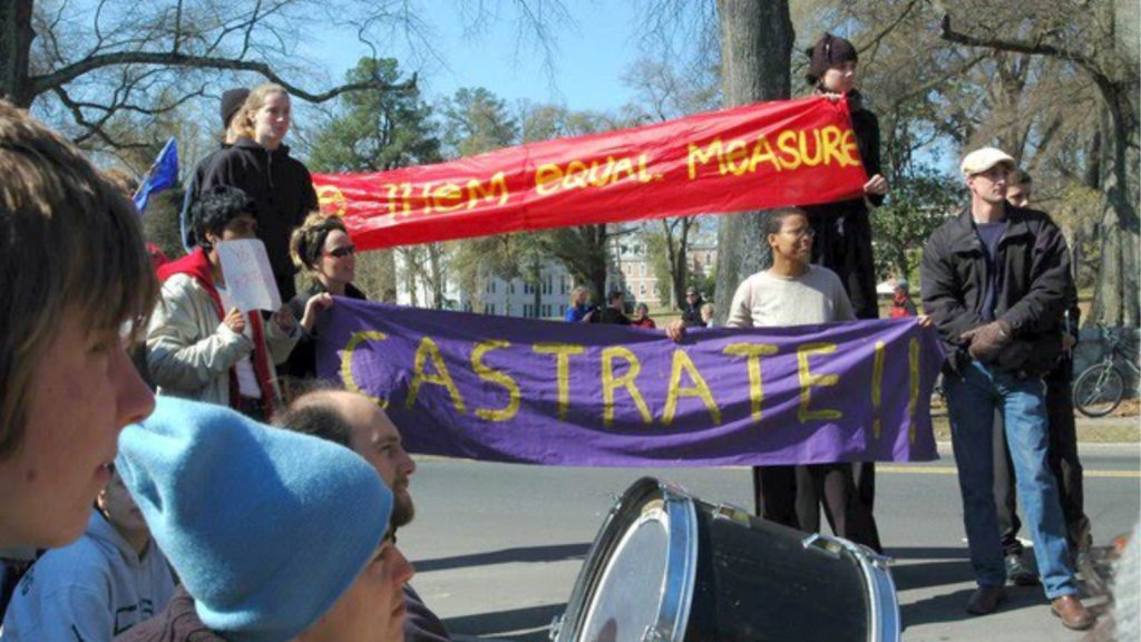 Student protesters hold banners that read "CASTRATE" and "give them equal measure."