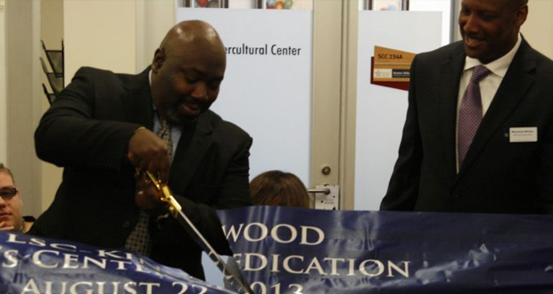 A photo of men "cutting the tape" to announce the opening of the men's center at Lone Star College.