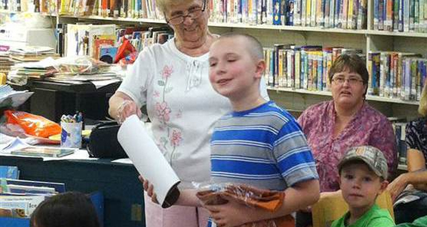 A photo of Tyler Weaver being happy after winning an award for reading.