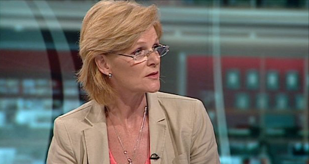 A still image of Mary Curnock Cook speaking at what appears to be a news interview.